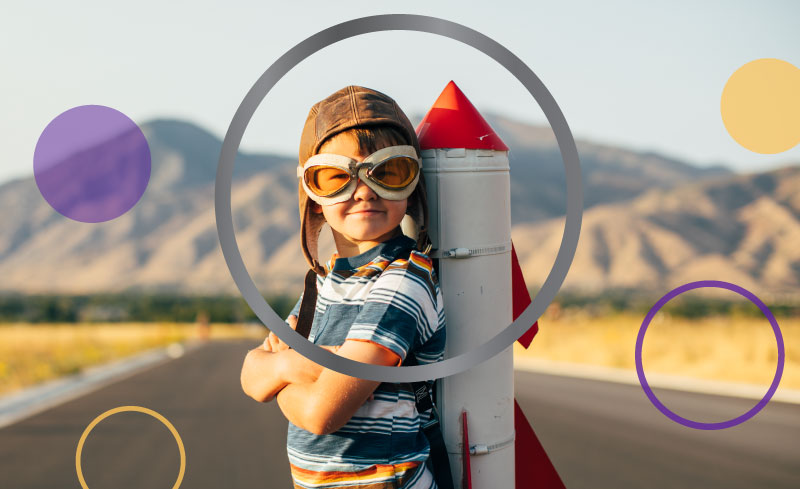 A child with a rocket pack stands proudly.